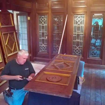 Doug Marvel at work on one of the intricate doors at the Parry Mansion